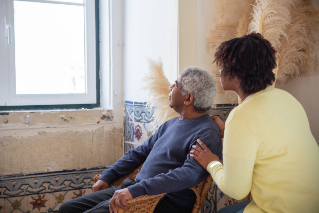 7551662-7551662 Elderly Man and Woman Looking Outside Window